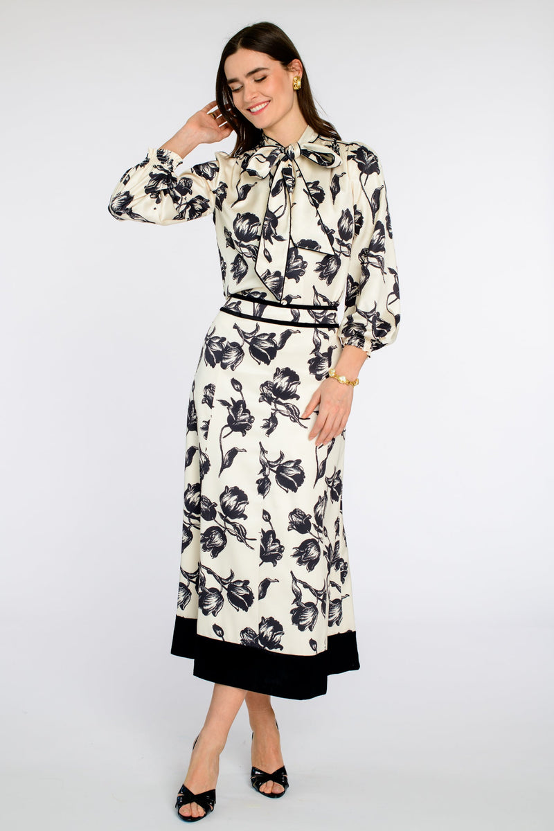 Woman wearing a floral dress with a belt on a white background