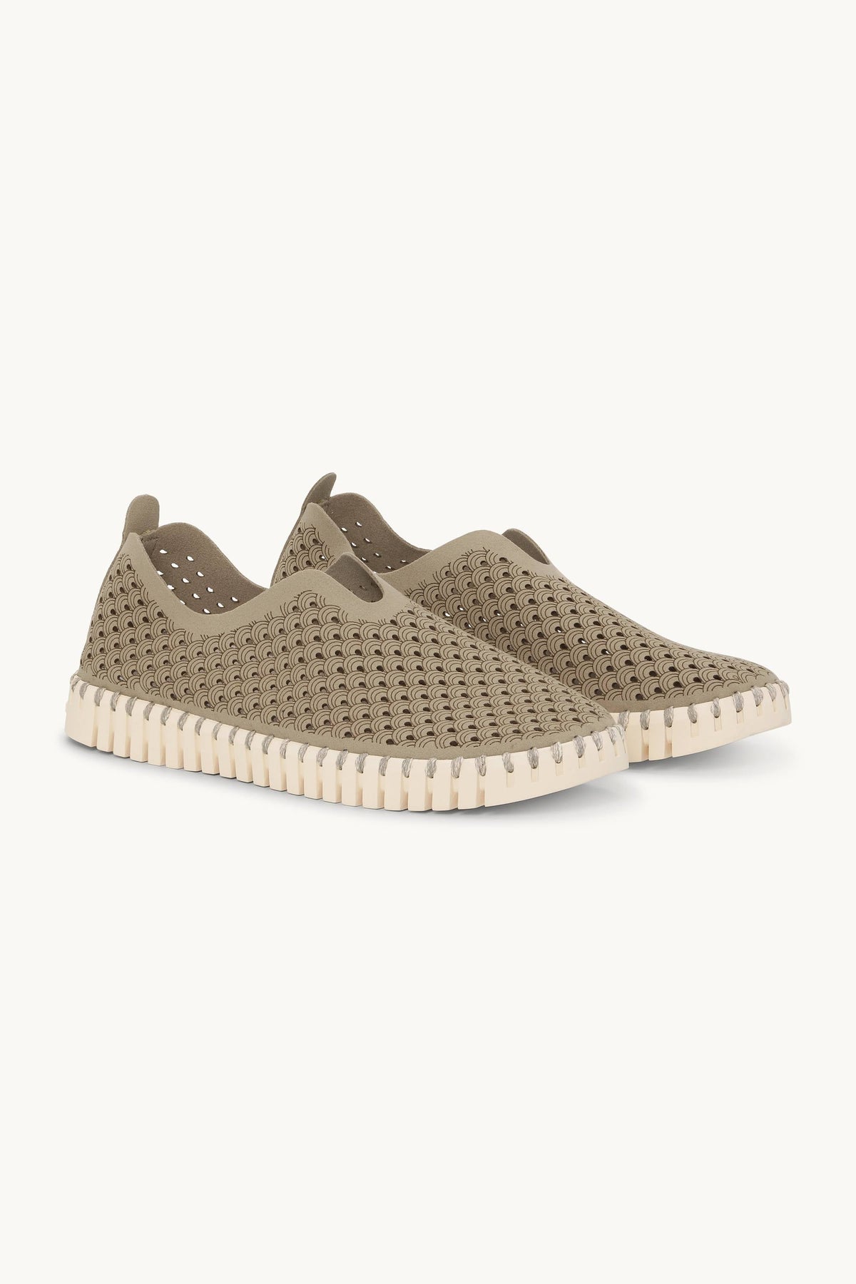 Green slip-on shoe with a thick white sole on a light gray background